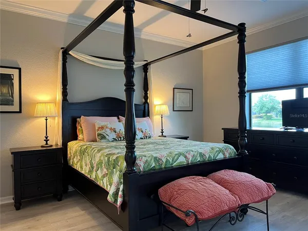 a bedroom with a bed window and a mirror