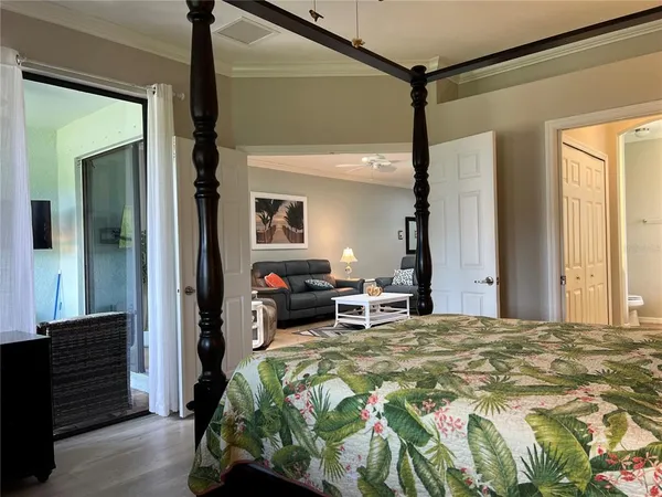 a bedroom with a bed and a mirror on the dresser