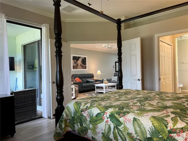 a bedroom with a bed and a mirror on the dresser