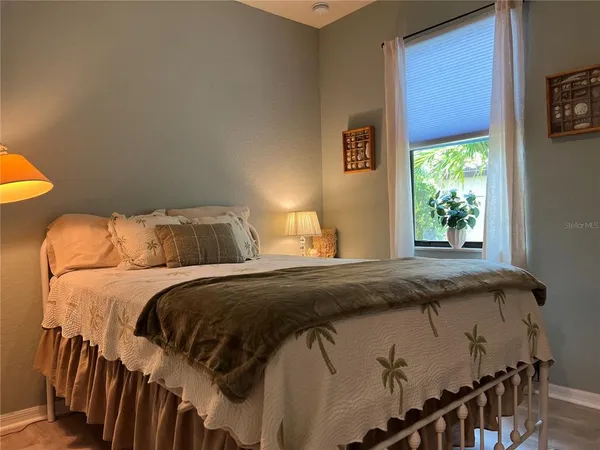 a bedroom with a bed and a table