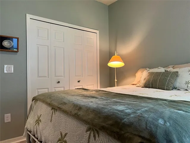 a bedroom with a bed and wall painting