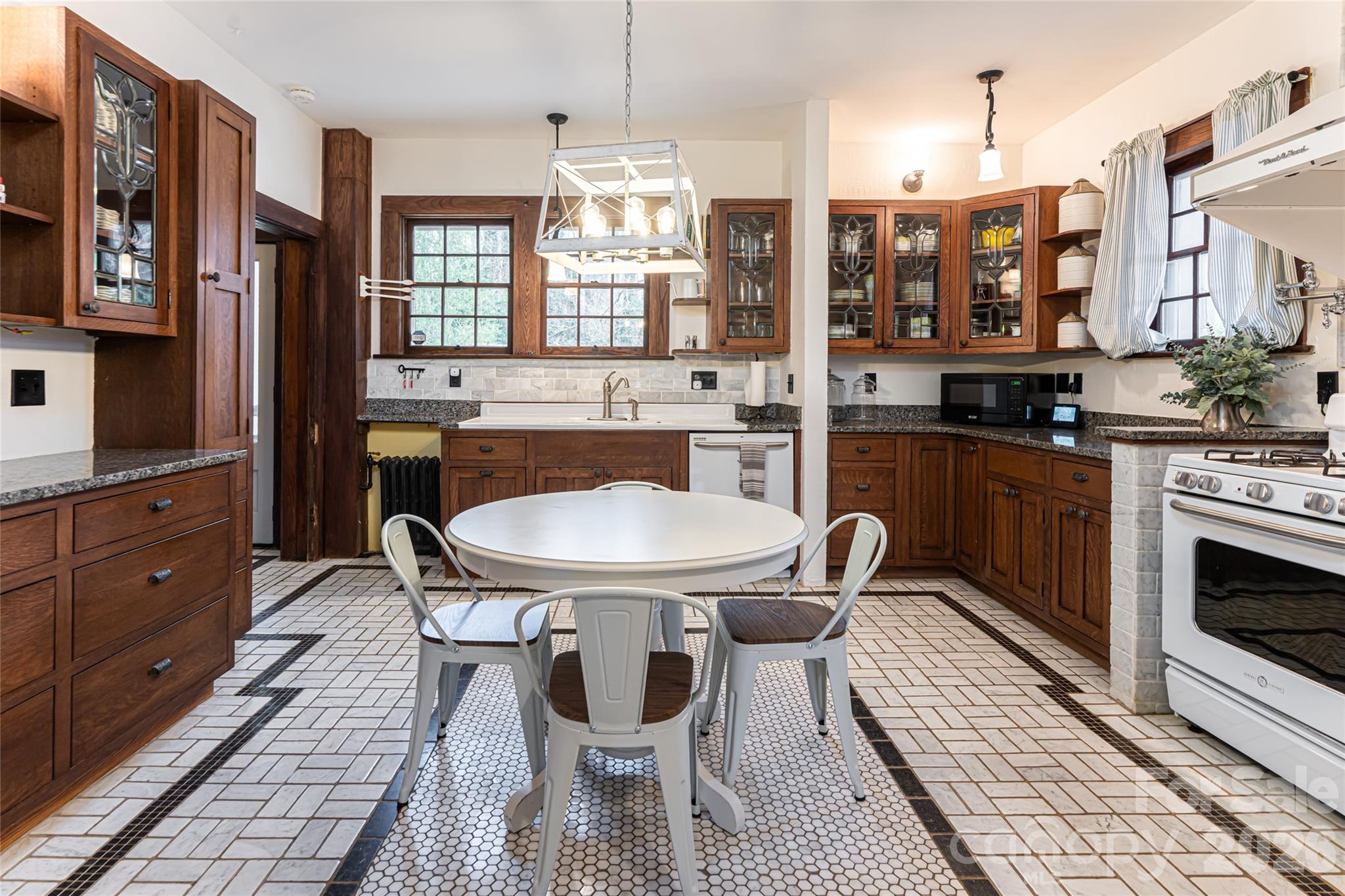 147 Preservation Way Waynesville, NC 28786 - Photo 14 of 48 a kitchen with stainless steel appliances a dining table chairs and granite counter tops