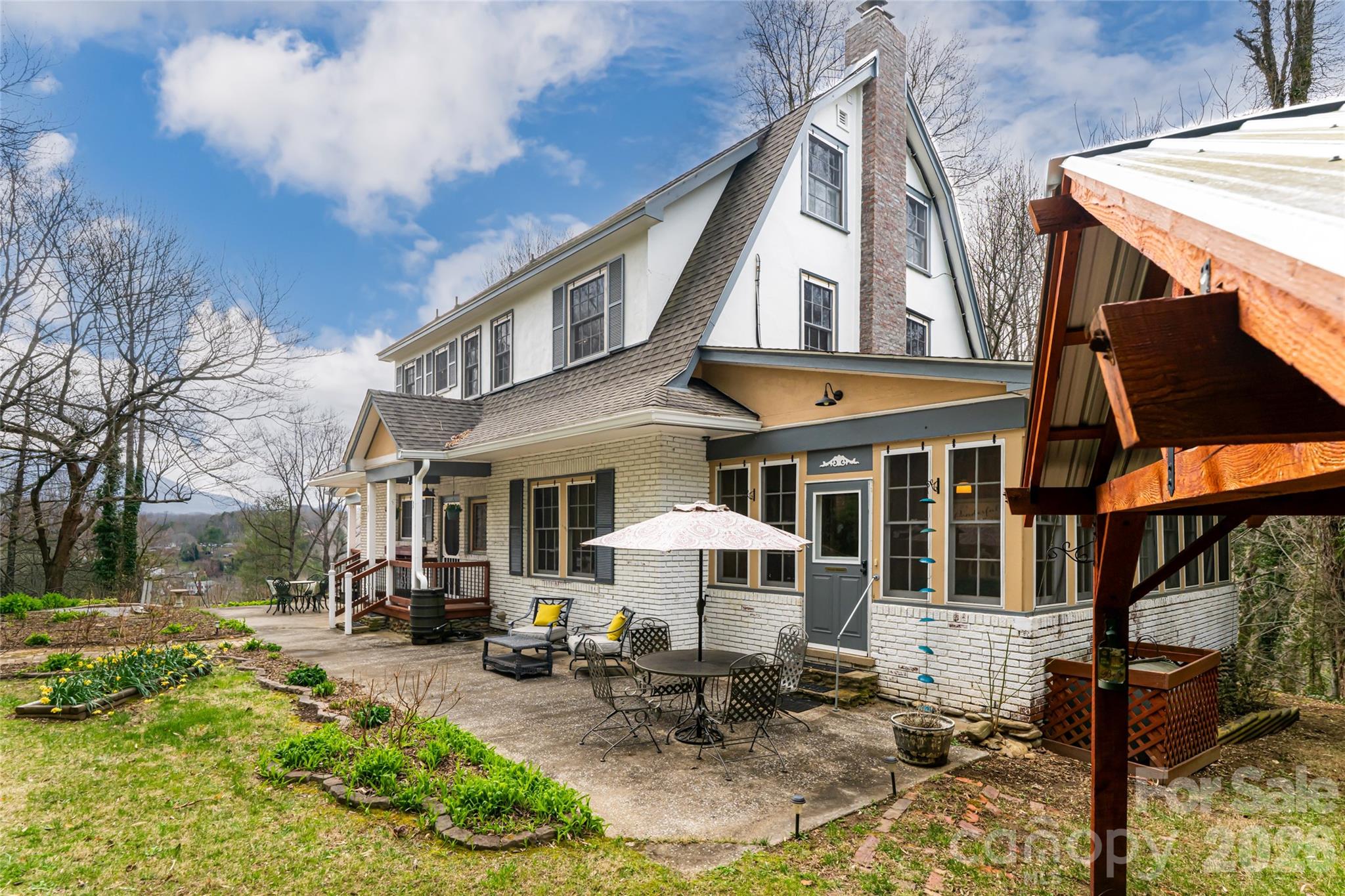 147 Preservation Way Waynesville, NC 28786 - Photo 44 of 48 a view of a building with a bench in front of house