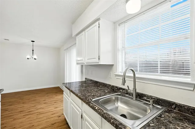 a kitchen that has a sink and a stove