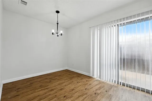a view of a room with wooden floor and window