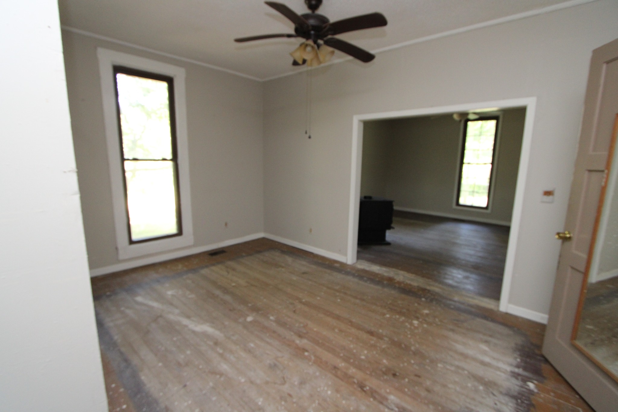 3182 Dodson Gap Road Culleoka, TN 38451 - Photo 2 of 15 an empty room with wooden floor and windows