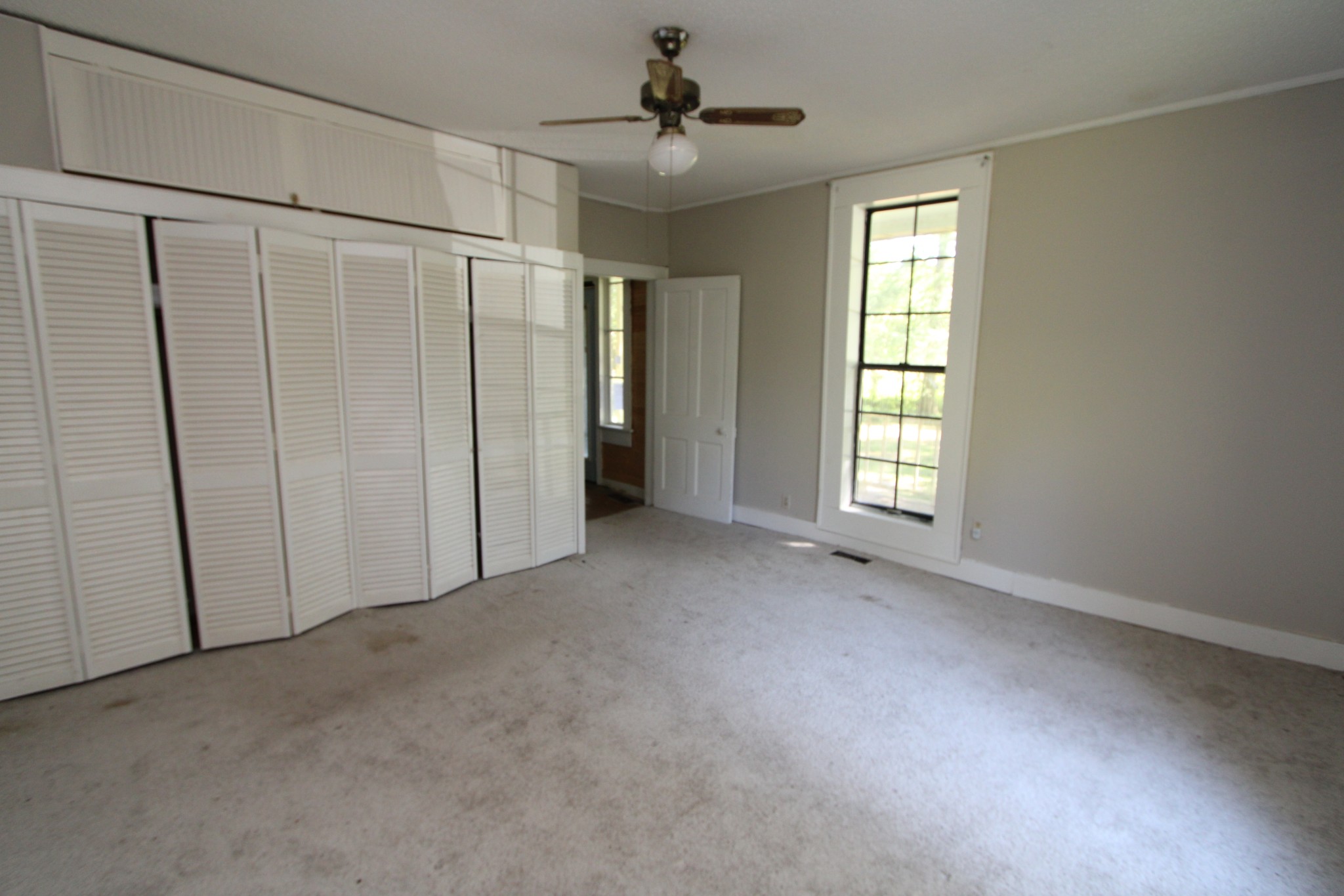 3182 Dodson Gap Road Culleoka, TN 38451 - Photo 5 of 15 an empty room with windows and fan