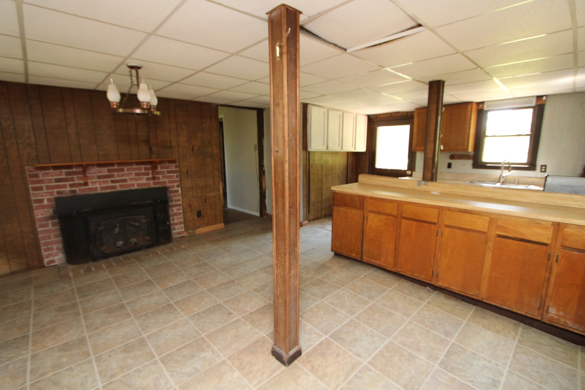 3182 Dodson Gap Road Culleoka, TN 38451 - Photo 8 of 15 a view of a kitchen with a sink and a fireplace
