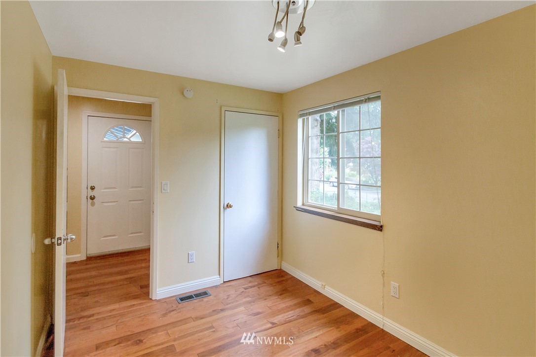 3726 199th Street Southeast Bothell, WA 98012 - Photo 2 of 18 a view of an empty room with wooden floor and a window