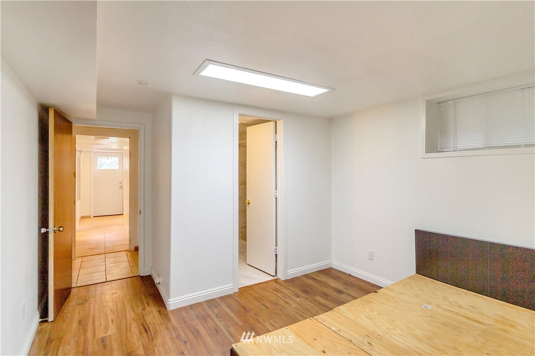 3726 199th Street Southeast Bothell, WA 98012 - Photo 11 of 18 a bedroom with a bed and wooden floor