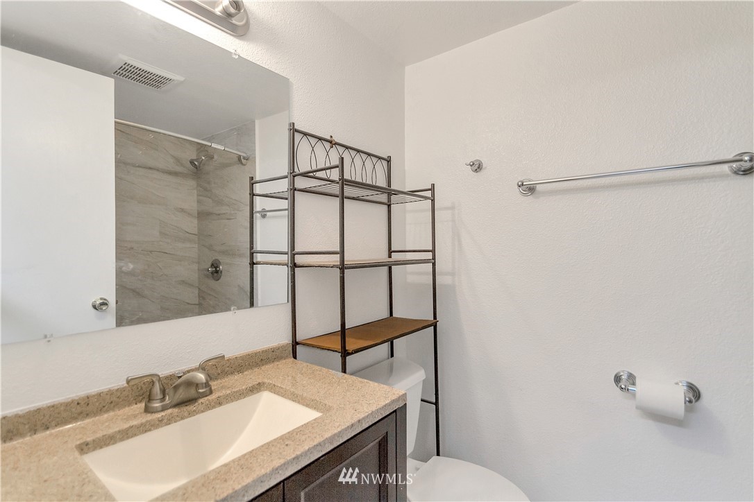 3726 199th Street Southeast Bothell, WA 98012 - Photo 12 of 18 a bathroom with a sink toilet a mirror and shower