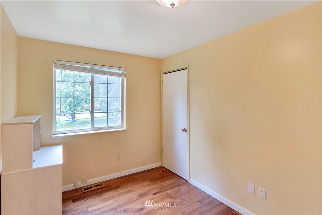 3726 199th Street Southeast Bothell, WA 98012 - Photo 3 of 18 a view of an empty room with wooden floor and a window