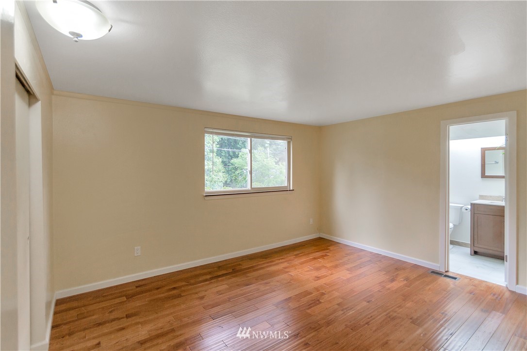 3726 199th Street Southeast Bothell, WA 98012 - Photo 6 of 18 an empty room with wooden floor and windows