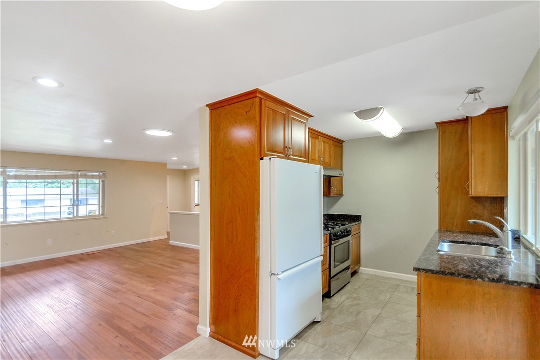3726 199th Street Southeast Bothell, WA 98012 - Photo 9 of 18 a kitchen with stainless steel appliances granite countertop a refrigerator and a sink