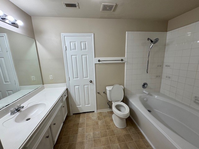 6815 Independence Boulevard Baytown, TX 77521 - Photo 18 of 24 a bathroom with a granite countertop toilet a sink and a bathtub