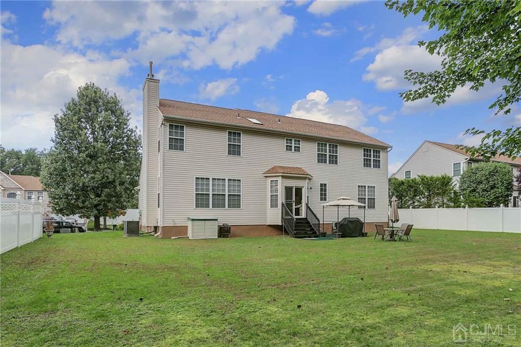 50 Stratton Road Old Bridge, NJ 07747 - Photo 15 of 15 a front view of a house with a garden and trees