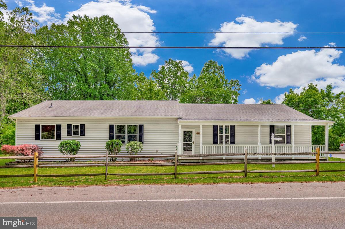 1955 Wilson Road Huntingtown, MD 20639 - Photo 1 of 45 a front view of a house with a big yard and potted plants
