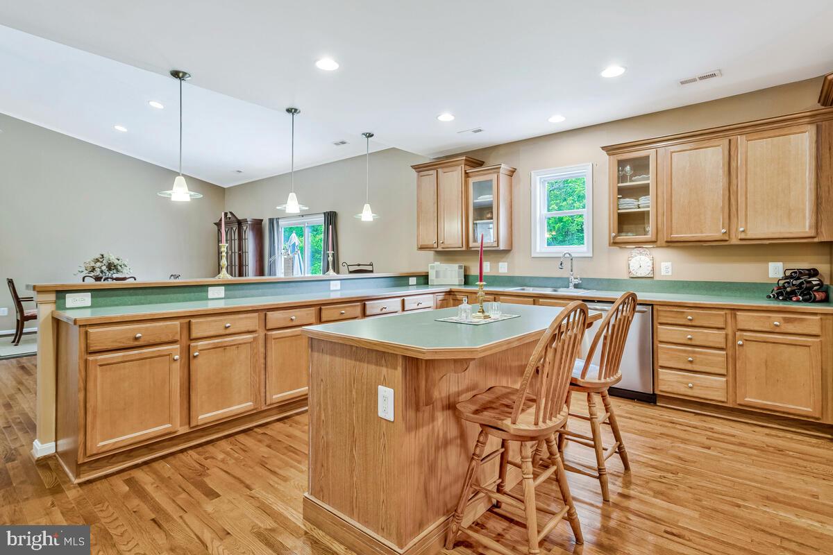 1955 Wilson Road Huntingtown, MD 20639 - Photo 12 of 45 a kitchen with stainless steel appliances granite countertop a stove a sink and a wooden cabinets