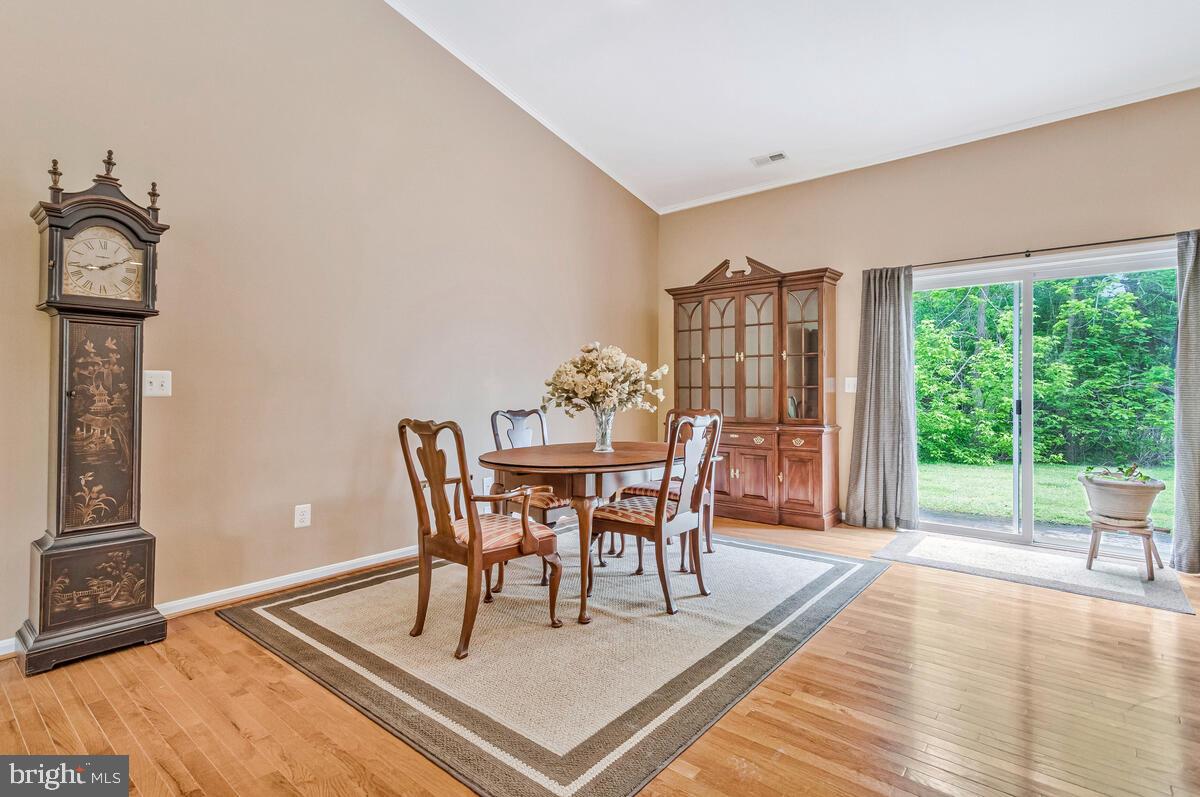 1955 Wilson Road Huntingtown, MD 20639 - Photo 13 of 45 a view of a dining room with furniture window and wooden floor