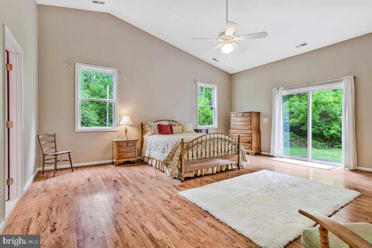 1955 Wilson Road Huntingtown, MD 20639 - Photo 19 of 45 a bedroom with a bed and a table