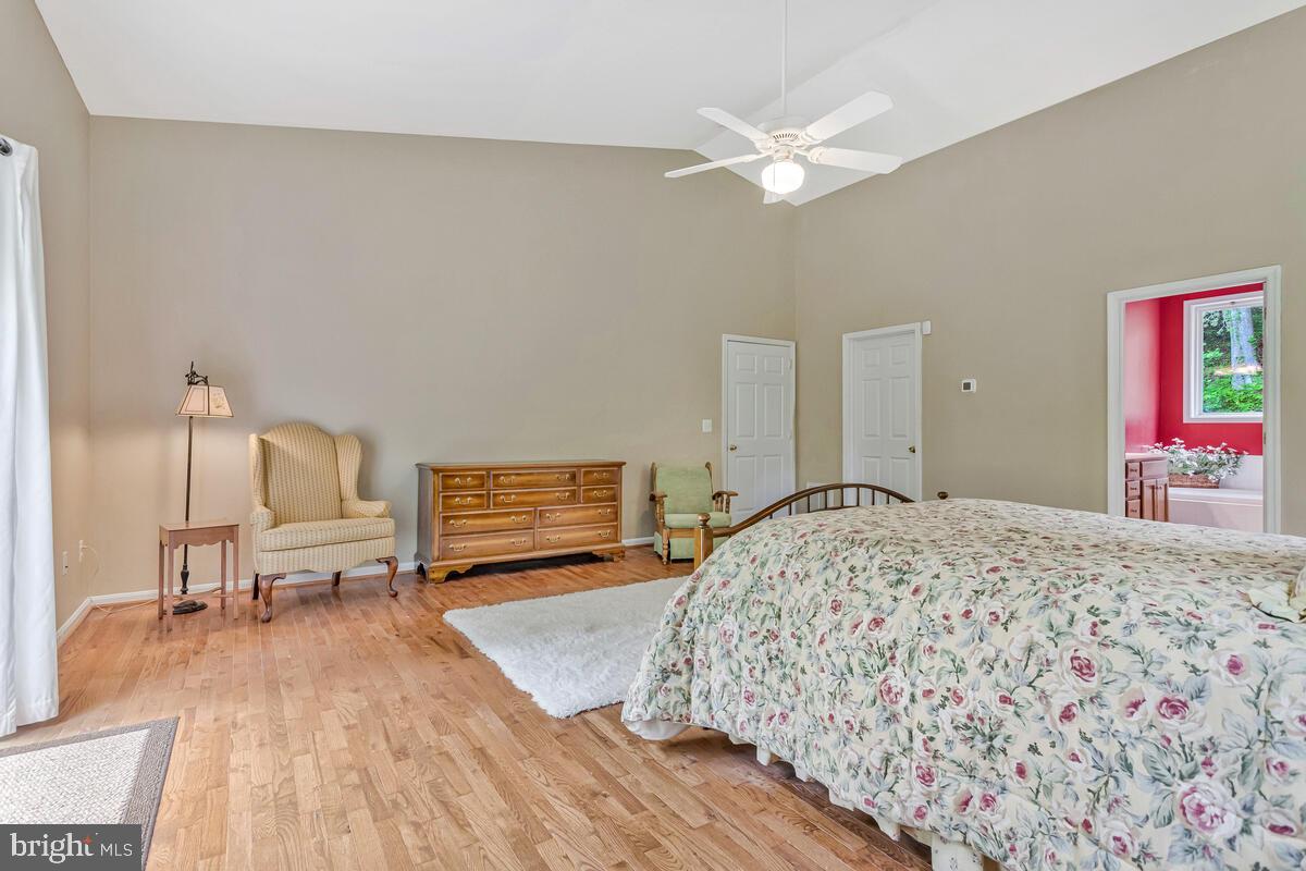 1955 Wilson Road Huntingtown, MD 20639 - Photo 23 of 45 a bedroom with a bed and a chandelier