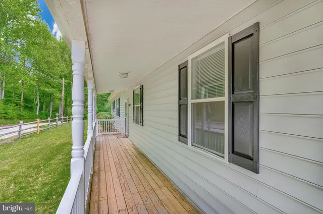 a view of balcony with wooden floor and fence
