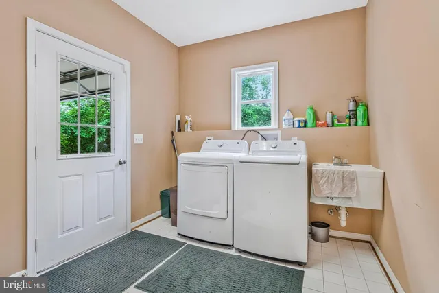 a view of kitchen with cabinets and window