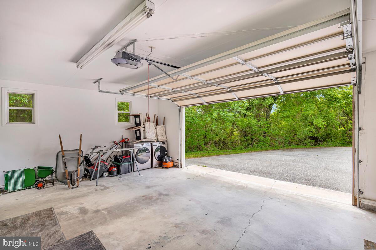 1955 Wilson Road Huntingtown, MD 20639 - Photo 33 of 45 a view of a garage with a bike and white car