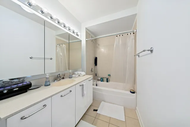 a bathroom with a double vanity sink mirror double and shower