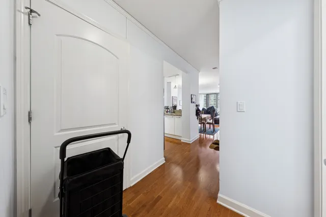 a view of a hallway with wooden floor and workspace