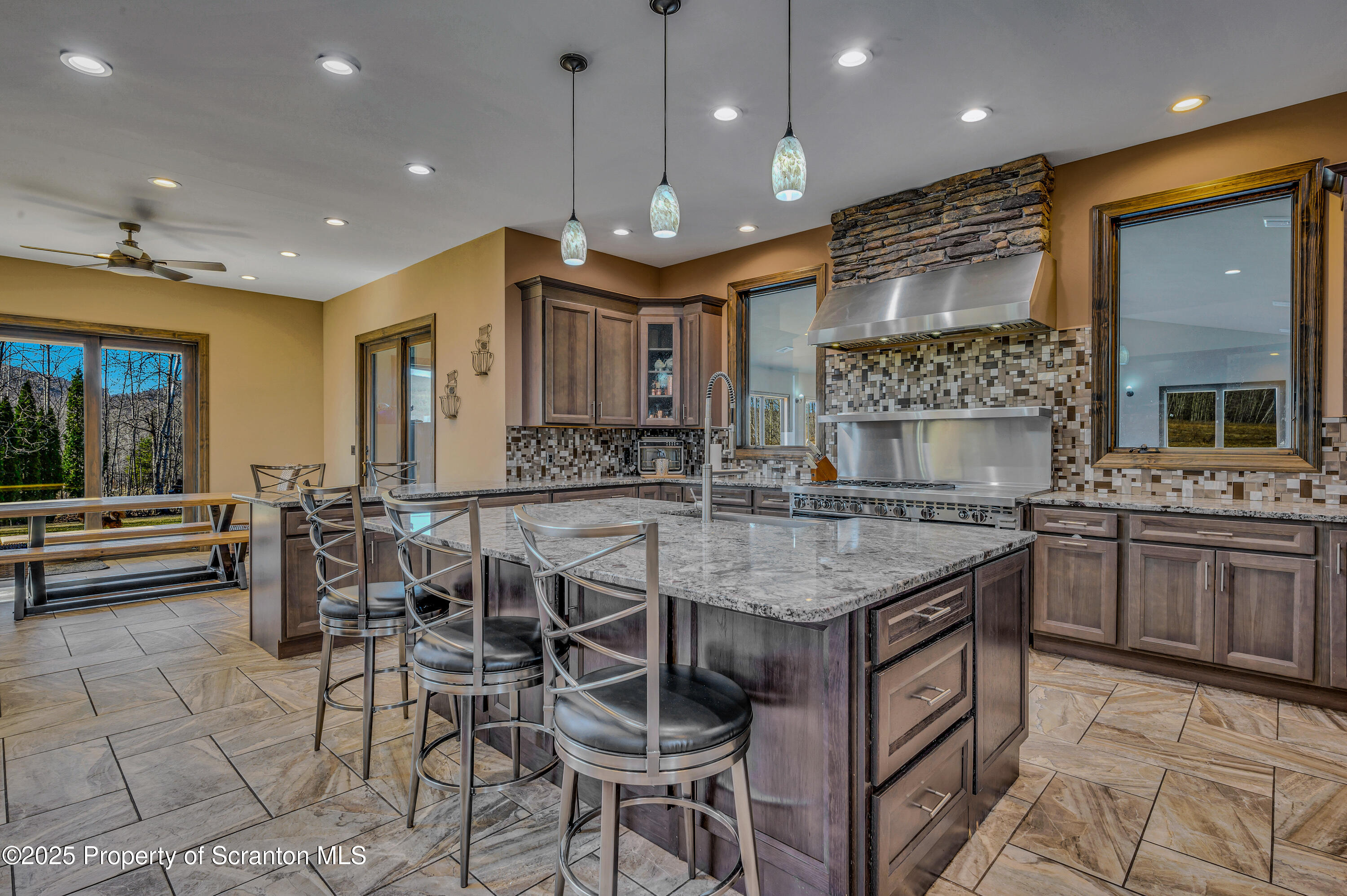 815 Oak Street Archbald, PA 18403 - Photo 14 of 85 a kitchen with stainless steel appliances granite countertop a stove a sink a oven a dining table and chairs