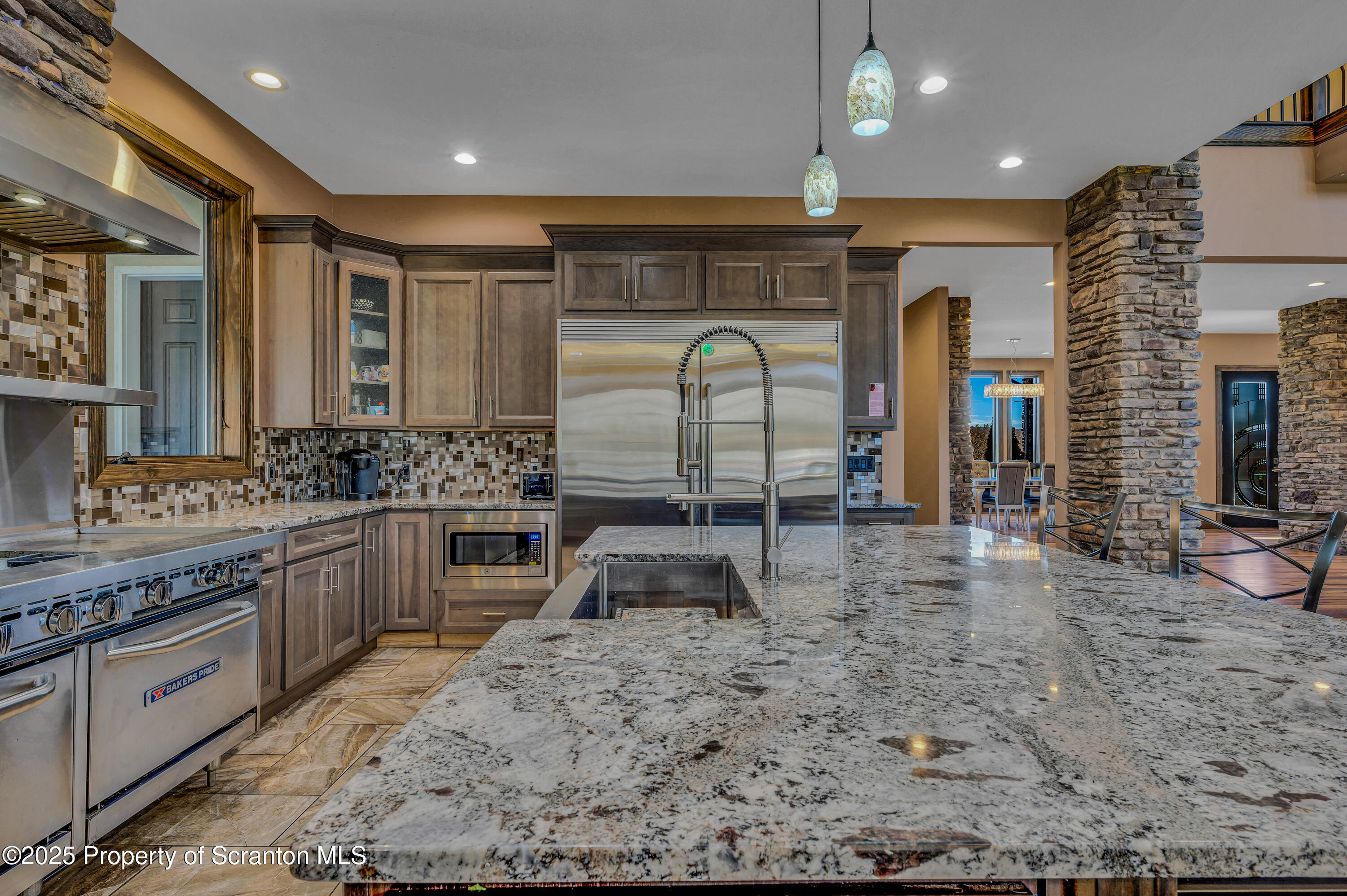 815 Oak Street Archbald, PA 18403 - Photo 16 of 85 a large kitchen with stainless steel appliances kitchen island granite countertop a stove and cabinets