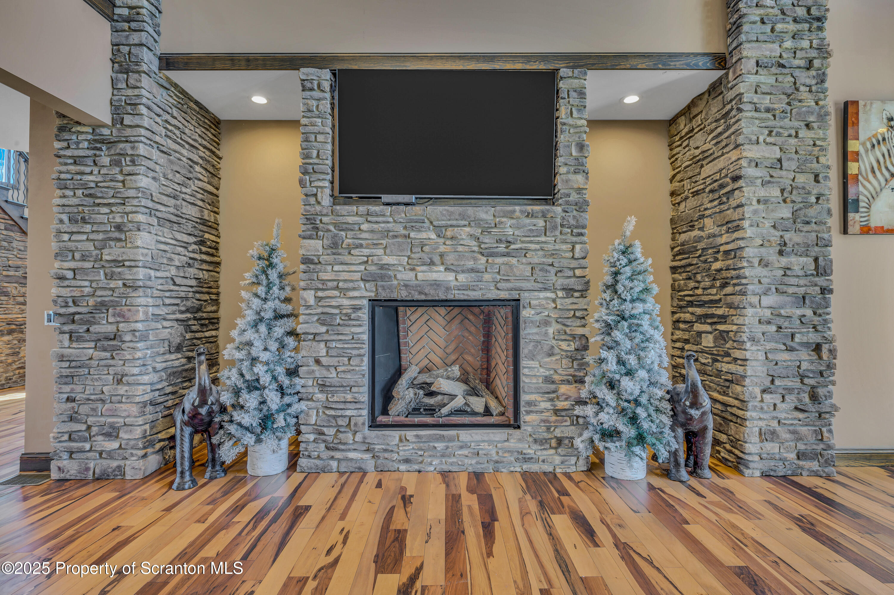 815 Oak Street Archbald, PA 18403 - Photo 28 of 85 a living room with a fireplace and a flat screen tv