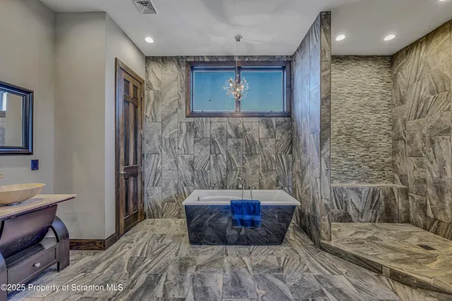 a view of a room that has a table and a chair in it