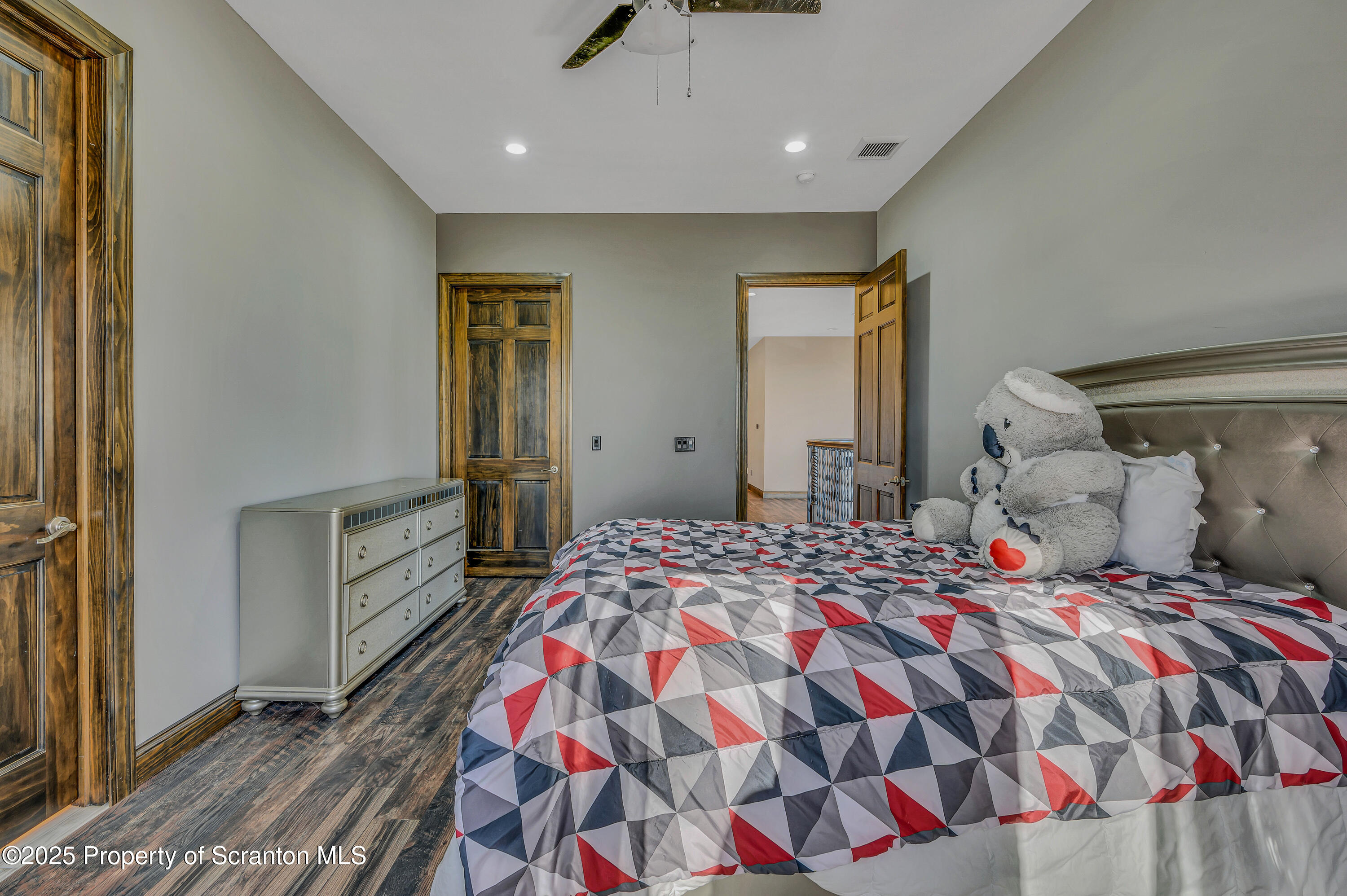 815 Oak Street Archbald, PA 18403 - Photo 76 of 85 a bedroom with a bed and a chandelier