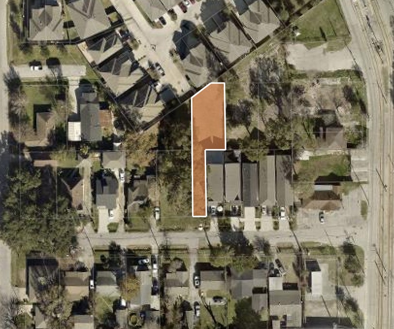 an aerial view of a residential apartment building with a yard