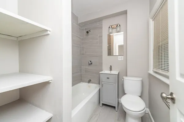 a white toilet sitting next to a bathroom sink