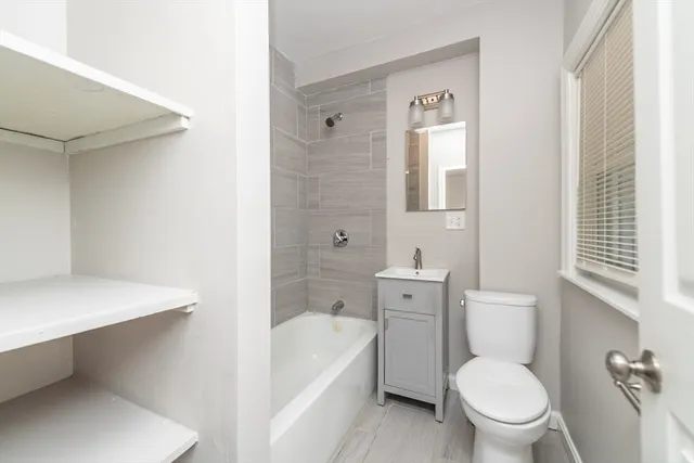 a white toilet sitting next to a bathroom sink