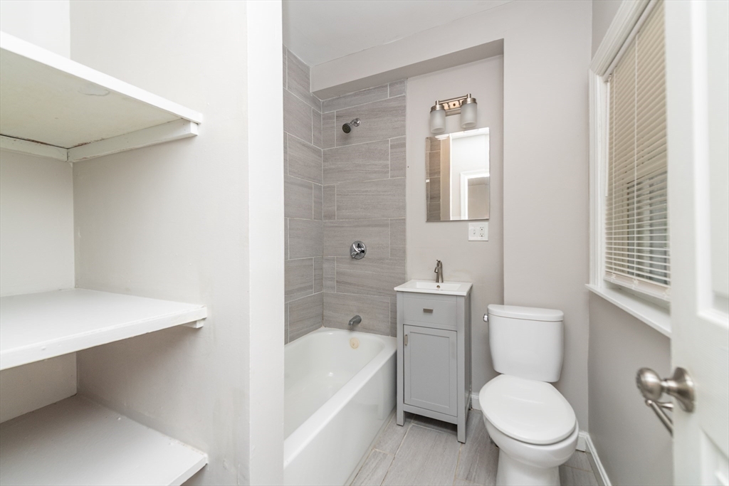 266-274 River Street Waltham, MA 02453 - Photo 15 of 27 a white toilet sitting next to a bathroom sink