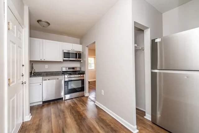 a kitchen with a refrigerator and a stove top oven