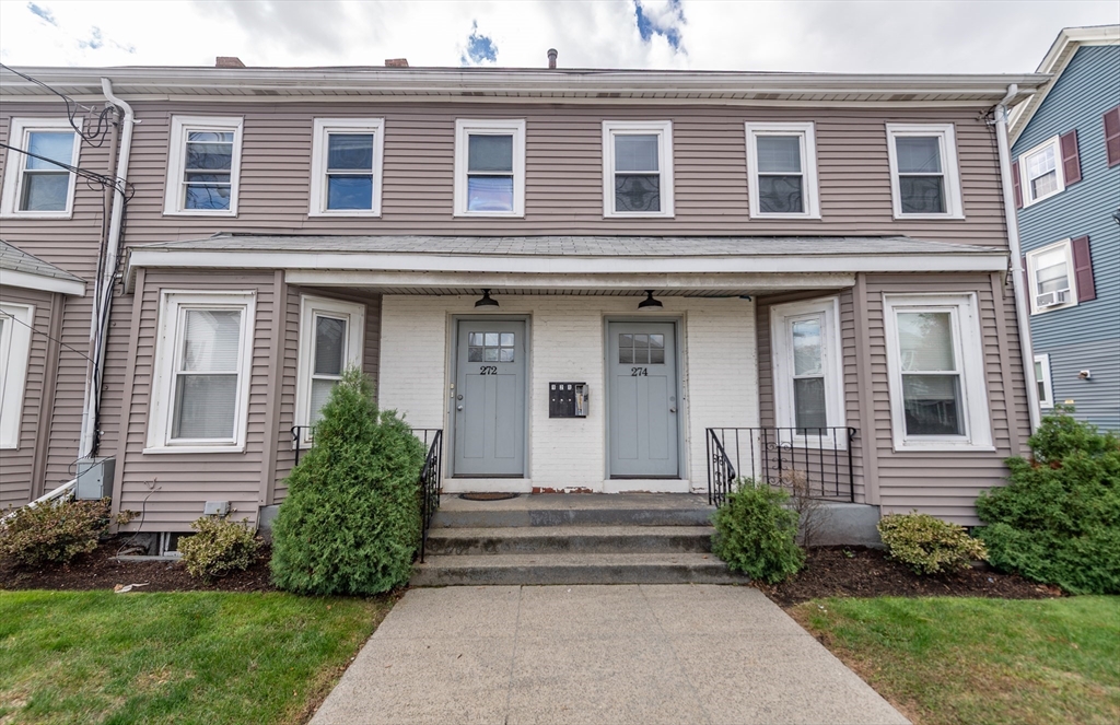 266-274 River Street Waltham, MA 02453 - Photo 2 of 27 a view of a house with a small yard and plants
