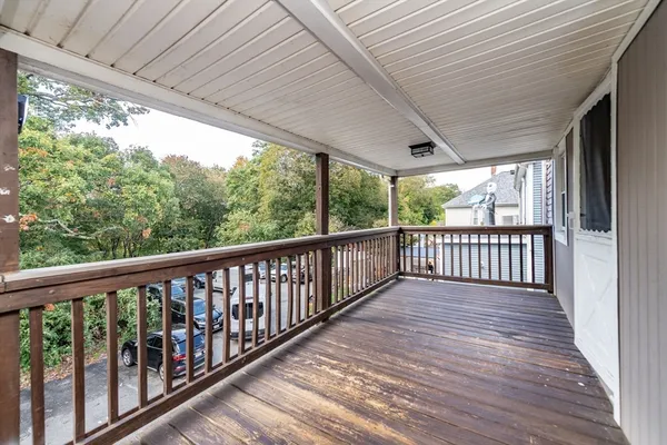 a view of a porch with wooden floor