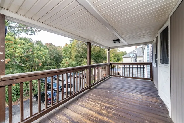 a view of a porch with wooden floor