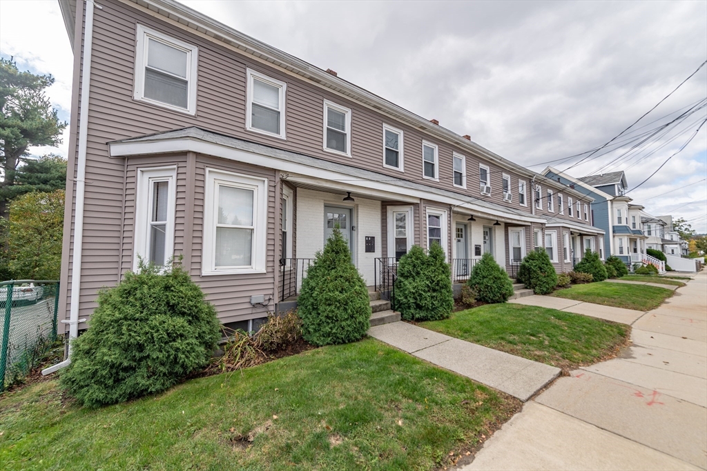 266-274 River Street Waltham, MA 02453 - Photo 5 of 27 a front view of a house with garden and porch
