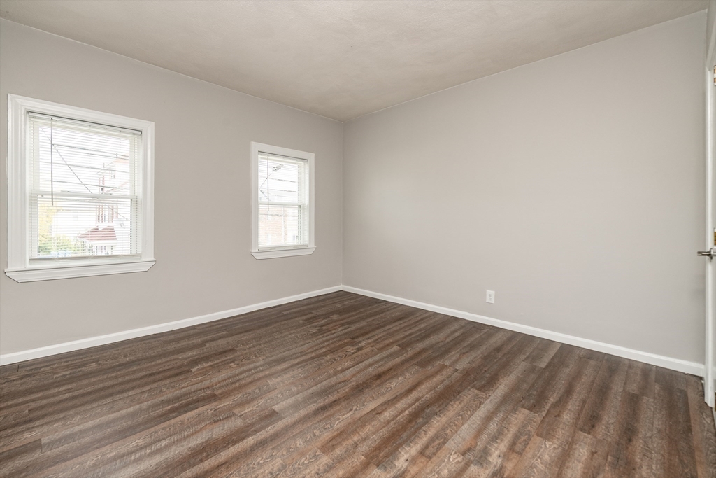 266-274 River Street Waltham, MA 02453 - Photo 7 of 27 a view of an empty room with wooden floor and a window