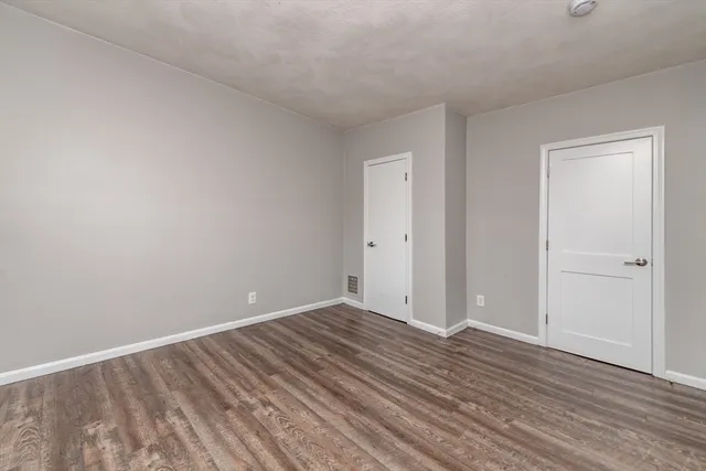 a view of room with wooden floor