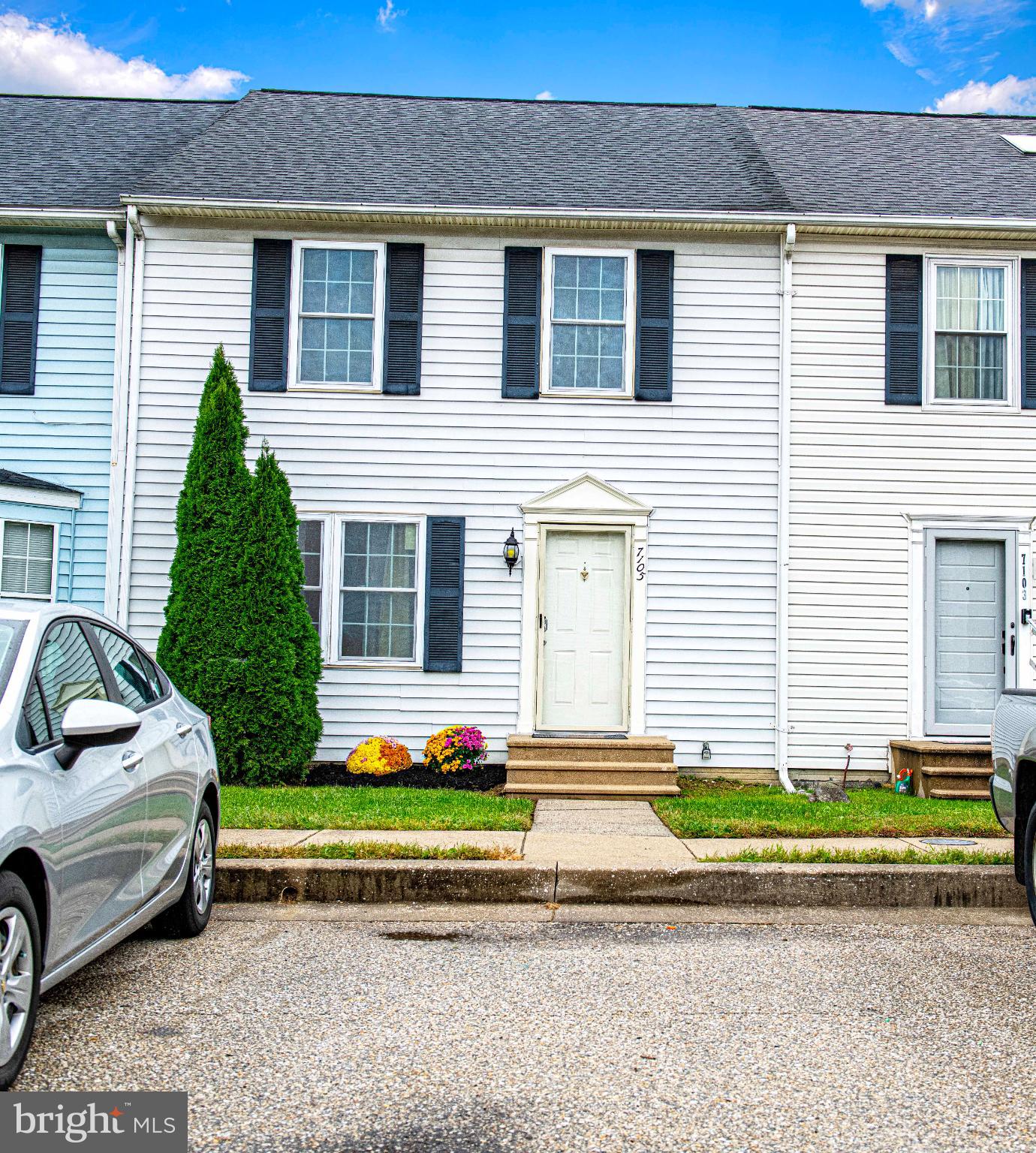 a front view of a house with a garden and plants