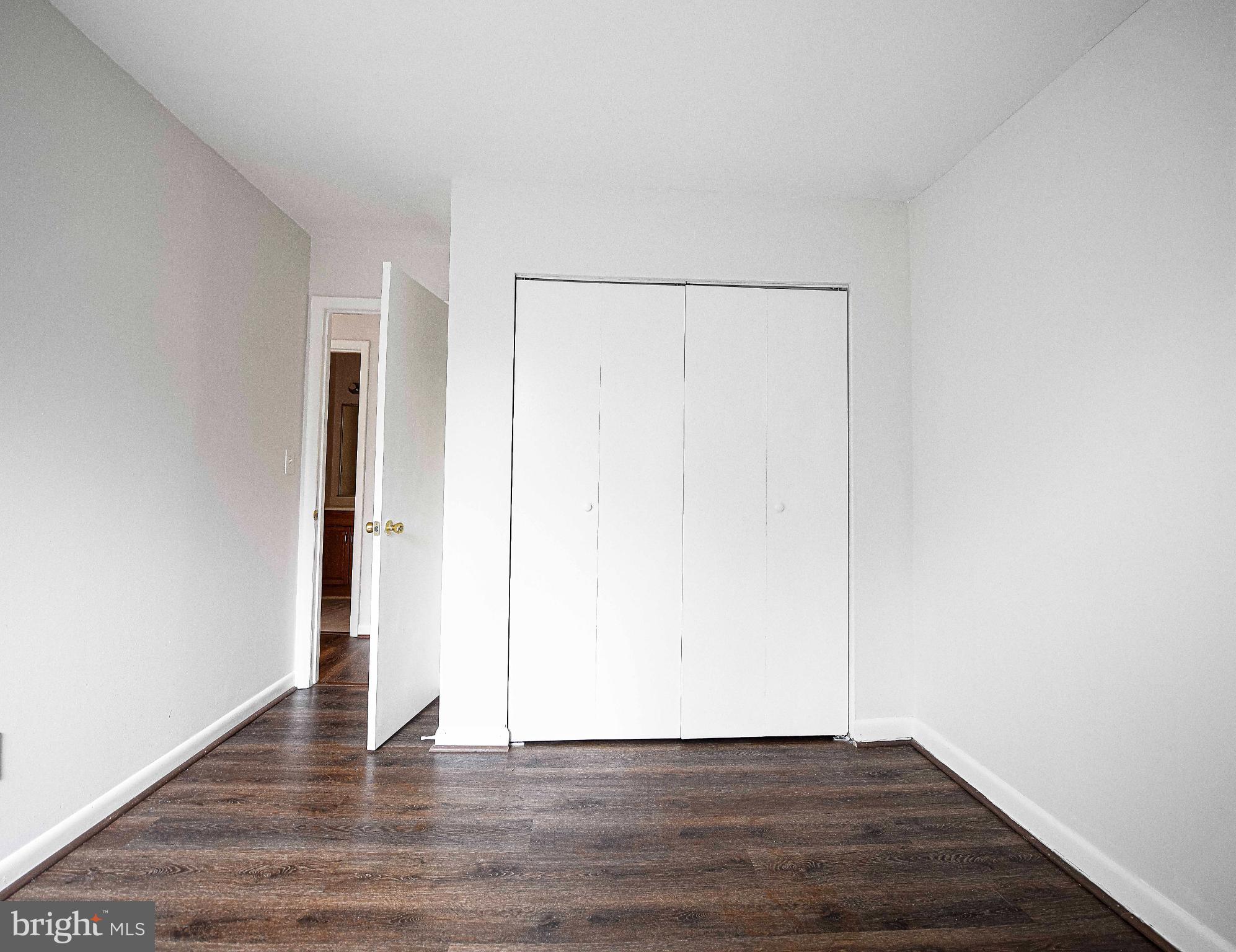 7105 Rutherford Green Circle Windsor Mill, MD 21244 - Photo 12 of 30 a view of an empty room with wooden floor