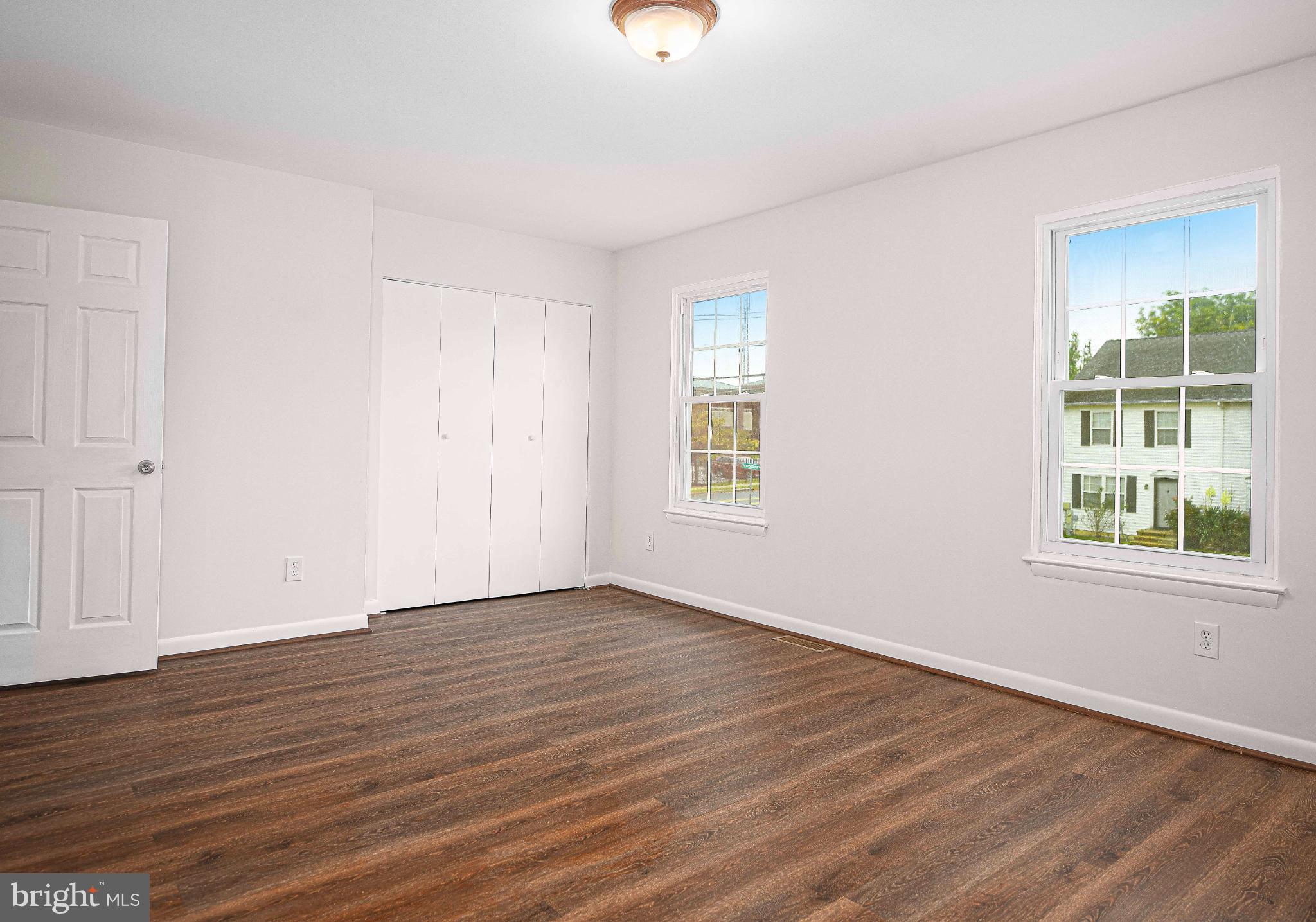 7105 Rutherford Green Circle Windsor Mill, MD 21244 - Photo 15 of 30 a view of an empty room with wooden floor and a window