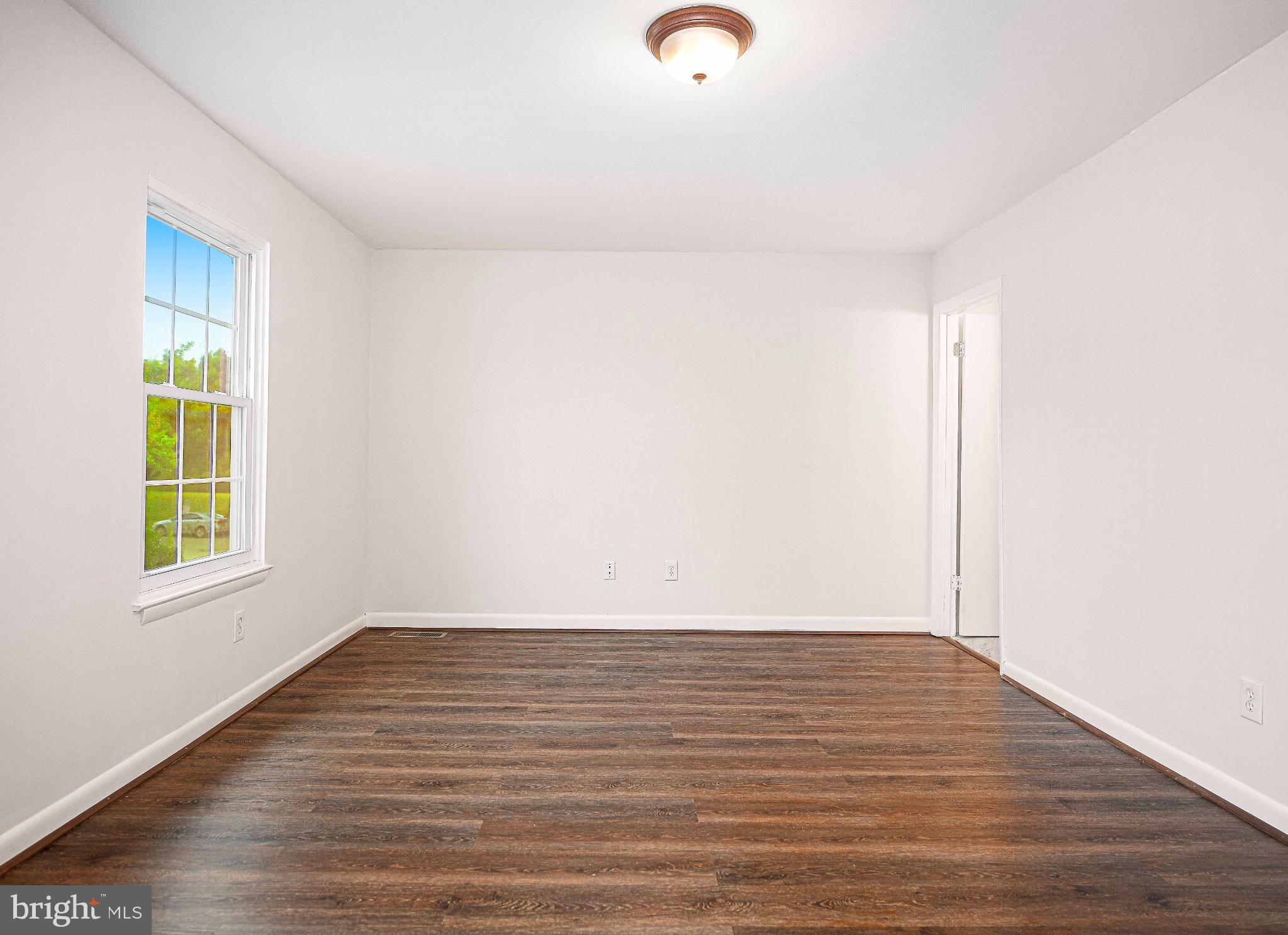 7105 Rutherford Green Circle Windsor Mill, MD 21244 - Photo 16 of 30 a view of room with window and wooden floor